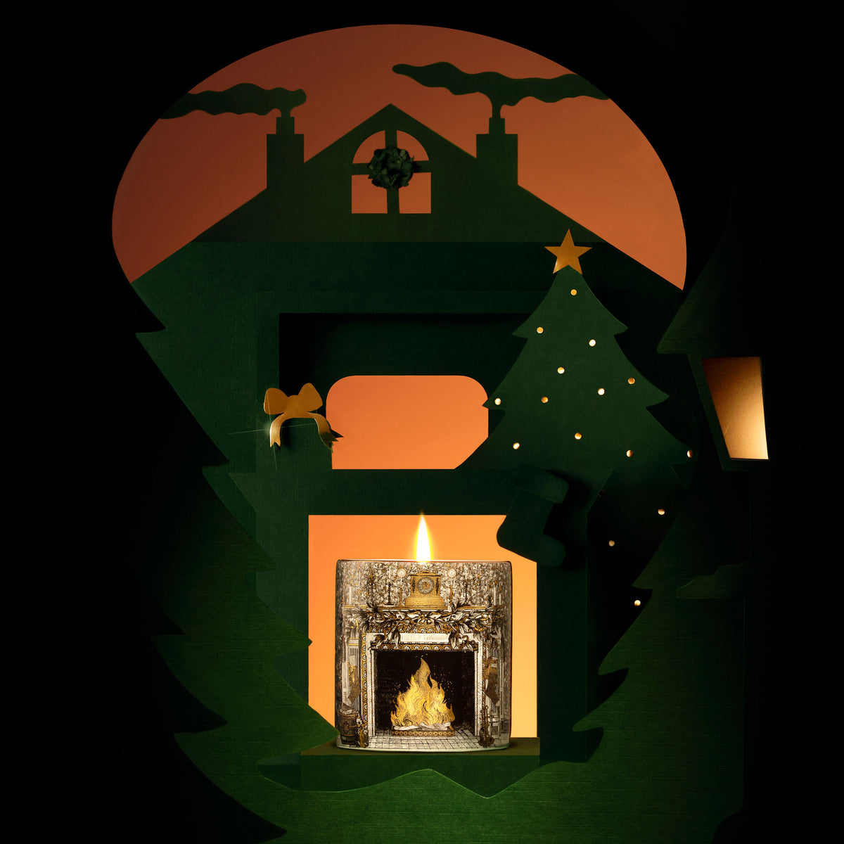 Home For Christmas ceramic candle lit inside a paper-cut Christmas house