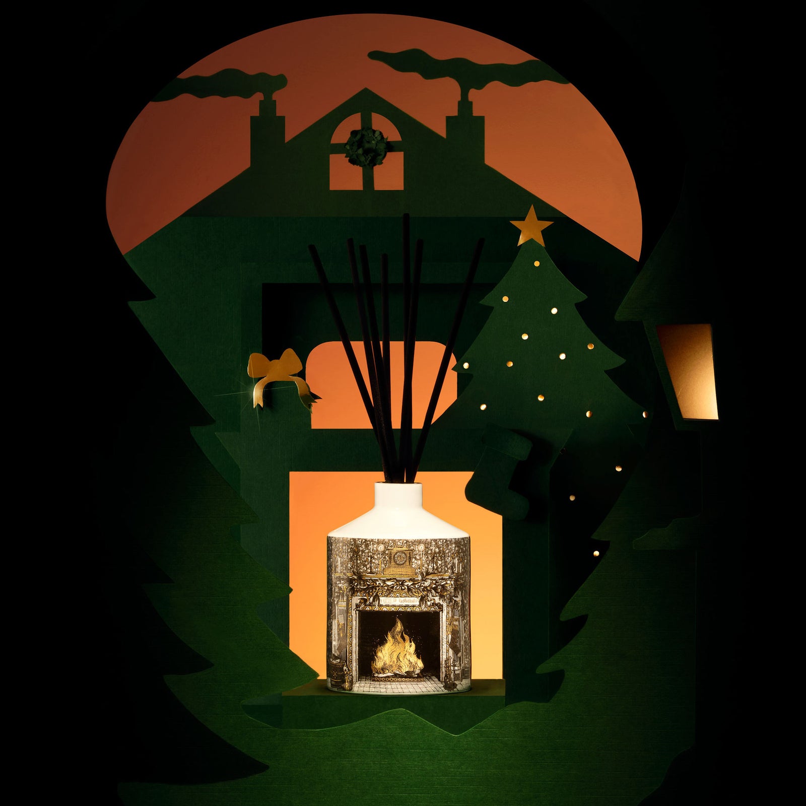 Home For Christmas Ceramic Reed Diffuser lifestyle shot with paper-cut house and chimneys background