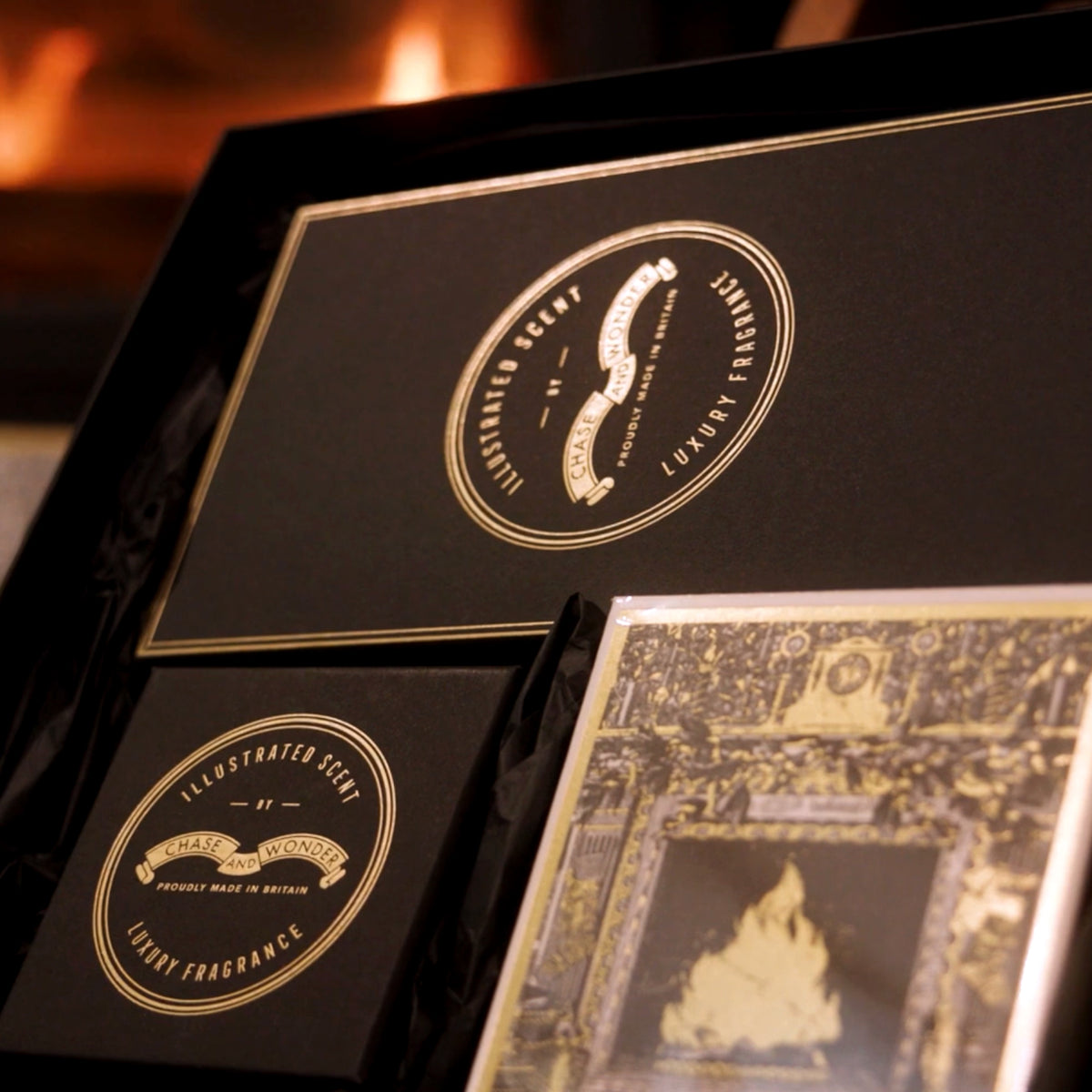 Chase and Wonder gift boxes with the Home For Christmas illustration, by the fire