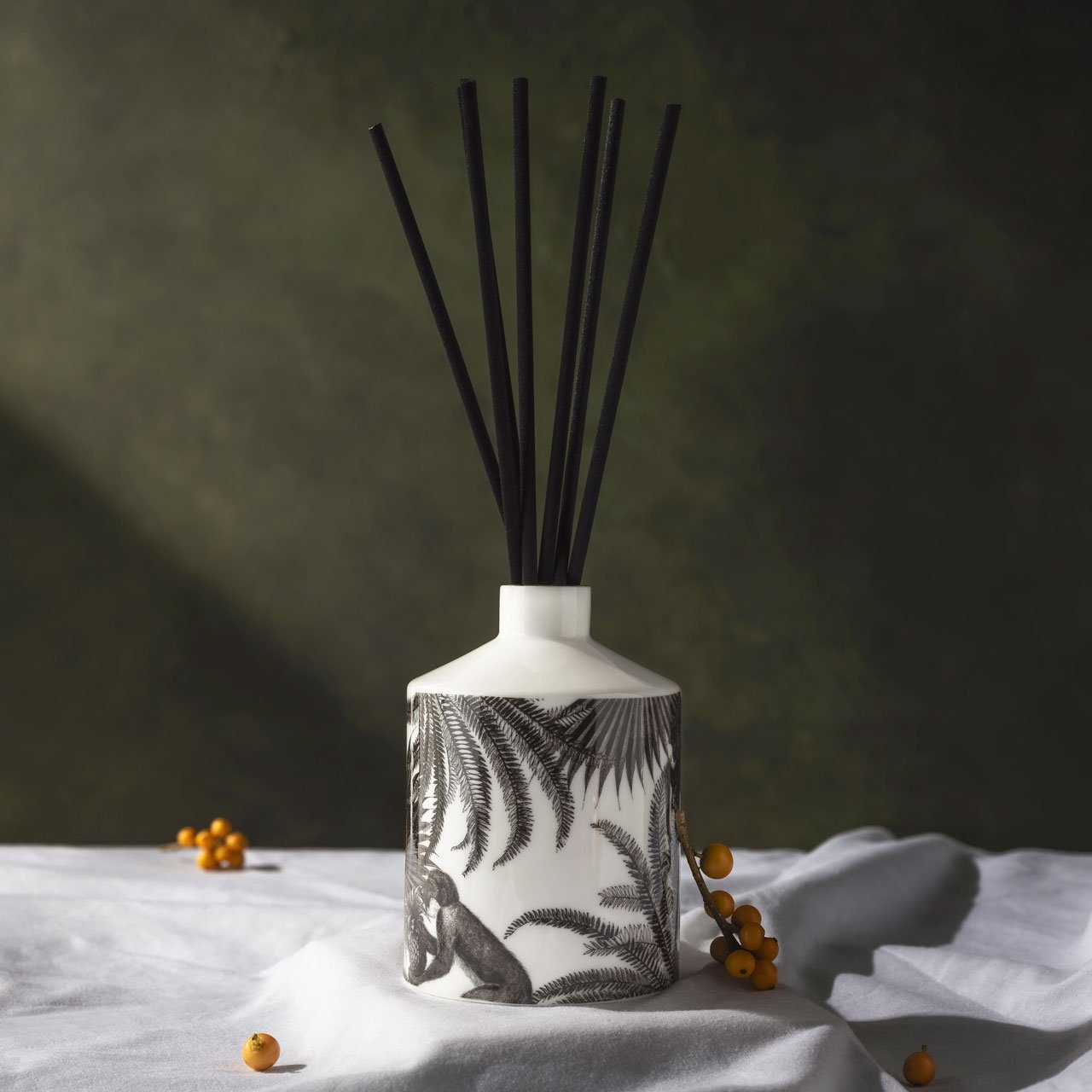 The Tropical Paradise ceramic reed diffuser, close-up of the hand-decorated illustration and 22ct gold